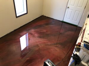 Metallic maroon swirl epoxy flooring in new bedroom